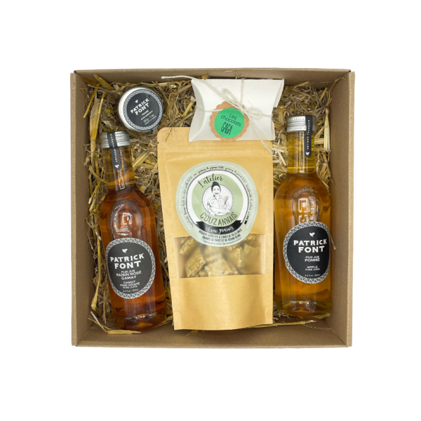 Contenu de la box jus de fruit, avec deux jus de fruit (pomme, raisin rosé), de la confiture, du chocolat et des biscuits apéritif.